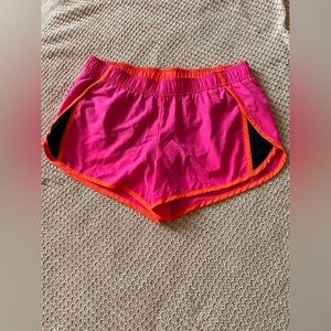 Hot pink and orange running shorts.